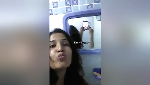 Sexy Indian babe in a swimsuit enjoys a relaxing bath