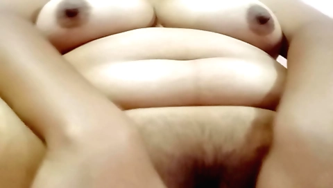 Hot brunette with a hairy pussy masturbating on her sofa