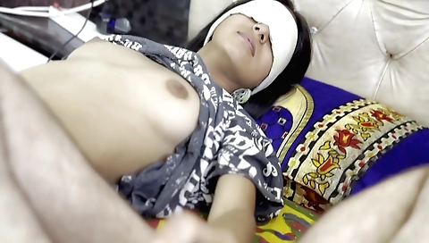 Indian girl wearing a pink dress is walking in her apartment